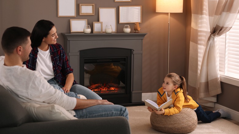family in front of fireplace