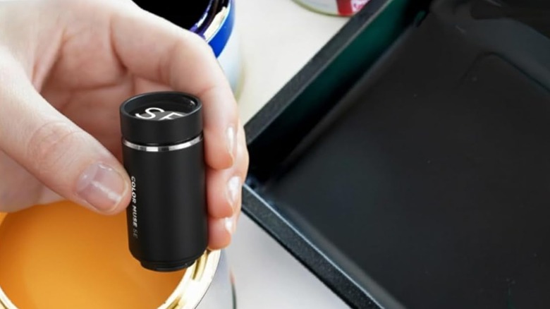 A person scanning paint can