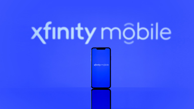 Xfinity Mobile promotional display with a smartphone