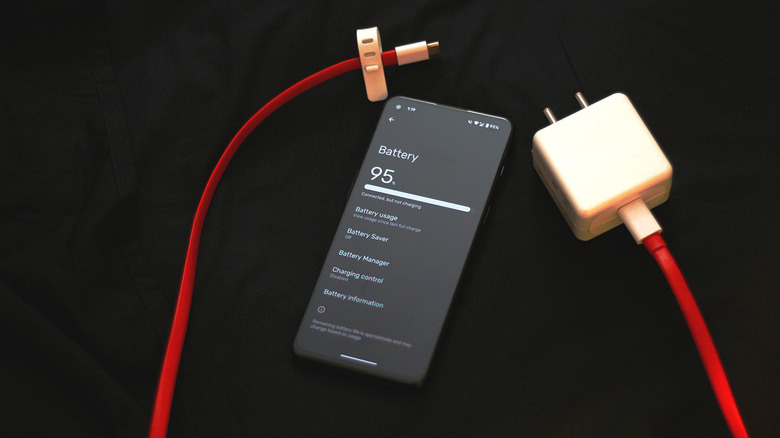 Android phone next to a charger