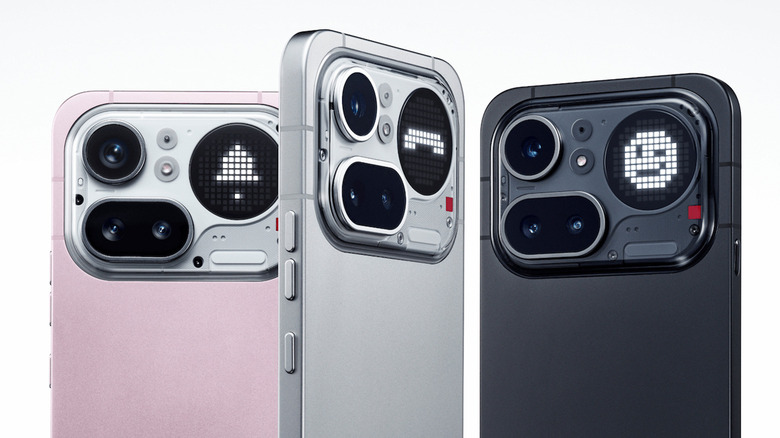 Three Nothing Phone 4(a) Pro phones in pink, silver, and black on a white background