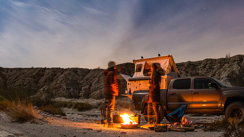 truck camping with campfire in the desert
