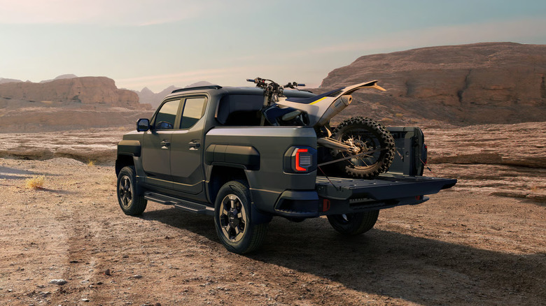 Kia Tasman off-roading with dirt bike