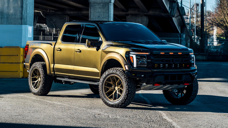 A green Ford Raptor R parked in an urban setting.