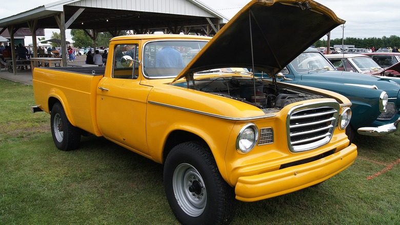 Yellow 1960 Studebaker Champ pickup truck at car show