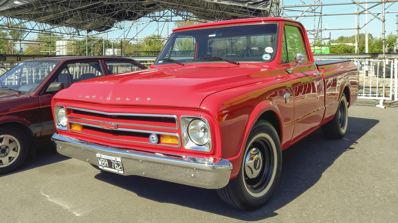 Classic red pickup truck in parking lot
