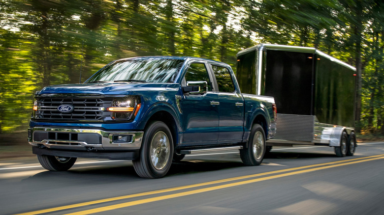 Blue Ford F-150 towing a trailer