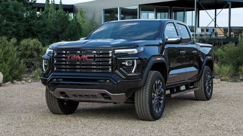 A 2026 black GMC Canyon in a gravel parking lot