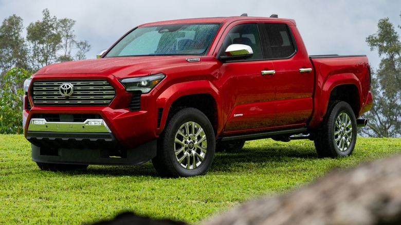 A red 2026 Toyota Tacoma in a field