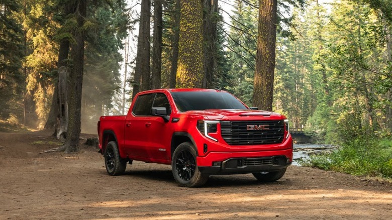 A red 2026 GMC Sierra 1500 in the woods