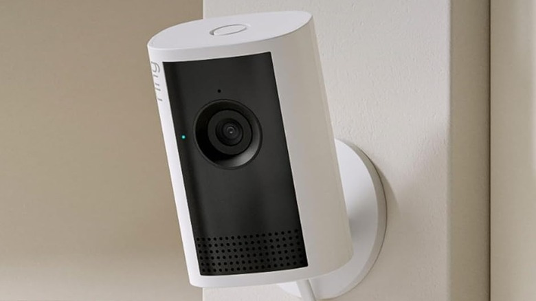 Ring Indoor Cam Plus on a wall near a coffee cup.