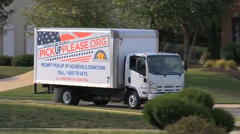 A Pickup Please box truck drives through a neighborhood
