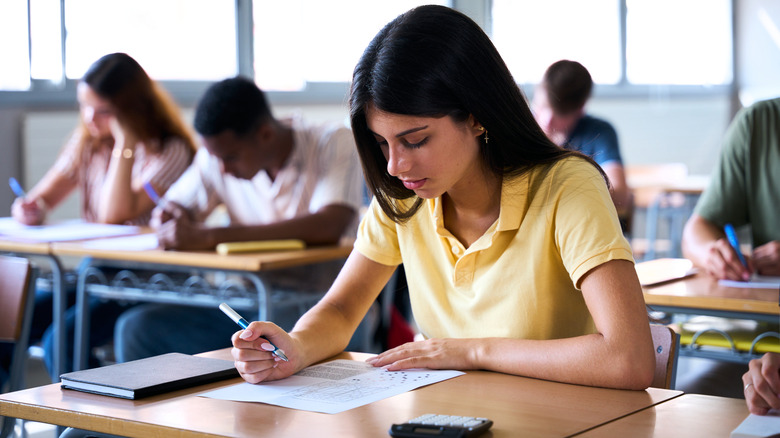 Students completing an exam paper.