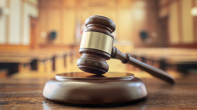 A judge's gavel in an empty courtroom.