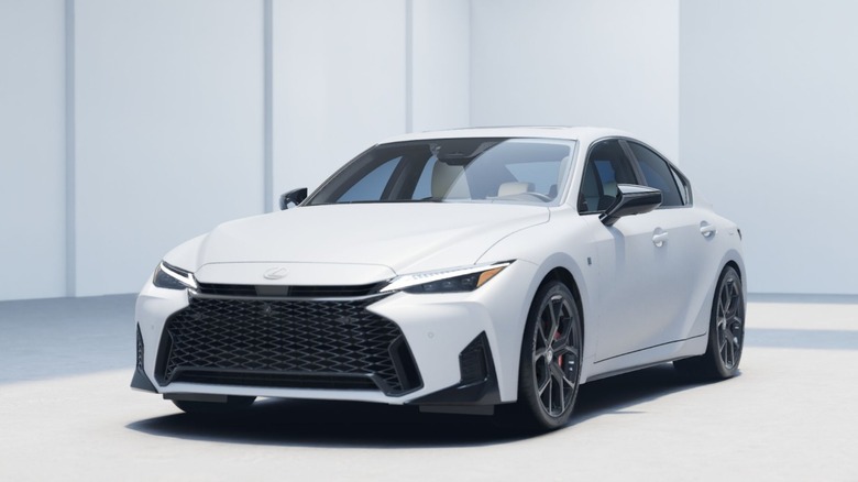 a white Lexus IS parked in a white garage