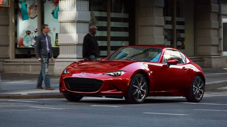 a red Mazda Miata turning a corner