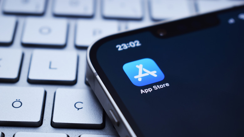 The App Store icon on an iPhone, resting on a computer keyboard.