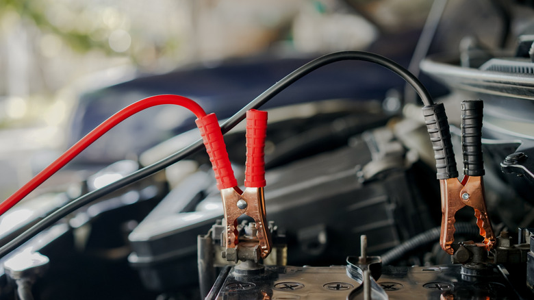 jumper cables attached to car battery