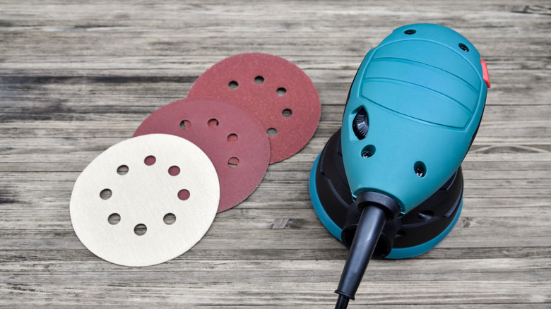 Random orbital sander and sanding discs on table