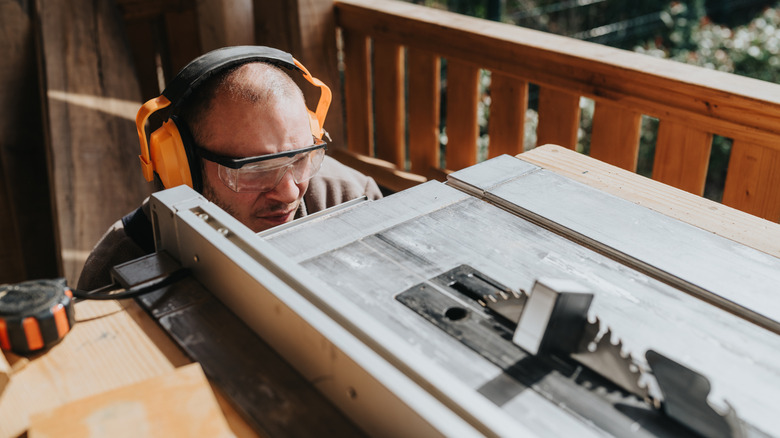 Person examining table saw