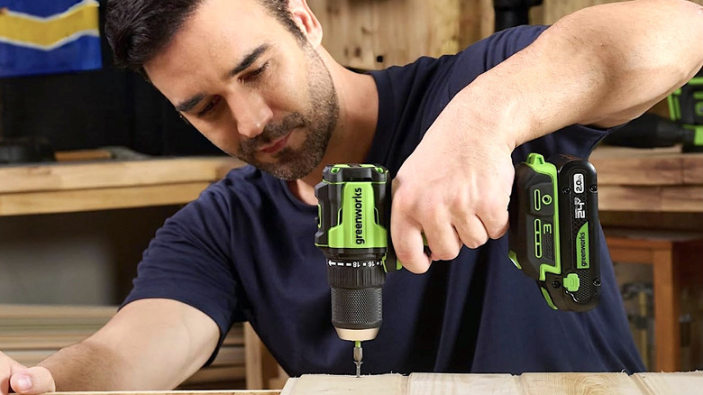 Person using Greenworks 24V power drill