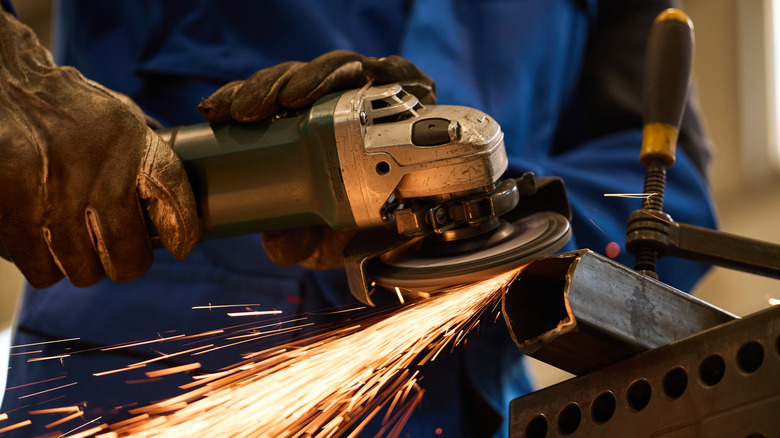 person creating sparks when using angle grinder