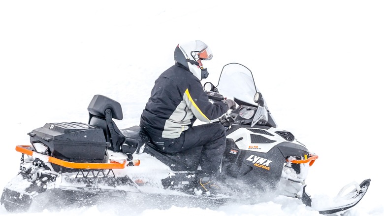 A man drifts on a snowmobile BRP Lynx