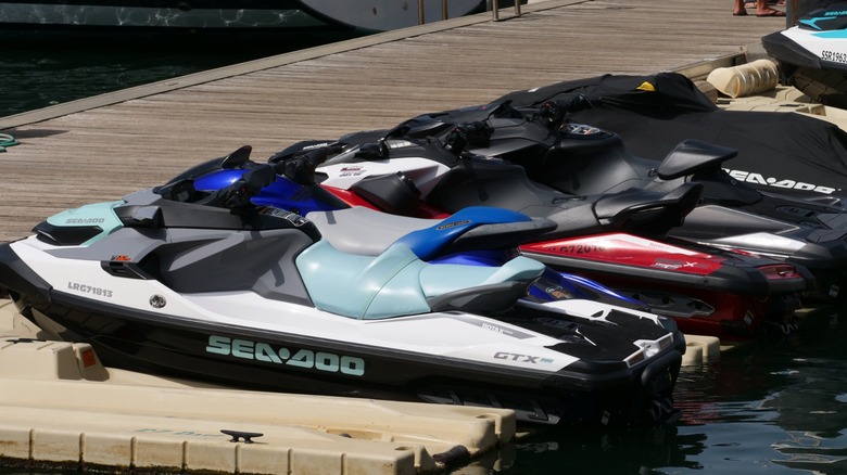 A row of sea-doo PWCs at a dock