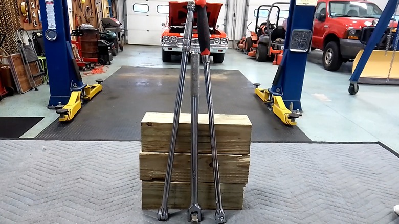 Three breaker bars in a garage.