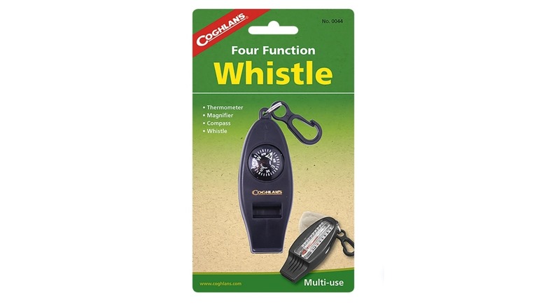 Coghlan's-branded whistle in packaging with compass dial and black plastic hook set against a white background