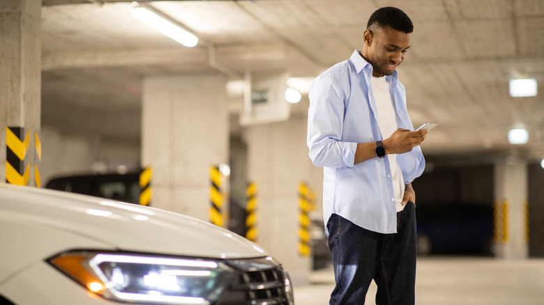 Man next to parked car