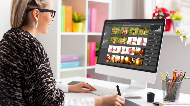 a woman editing photos on her Mac desktop computer