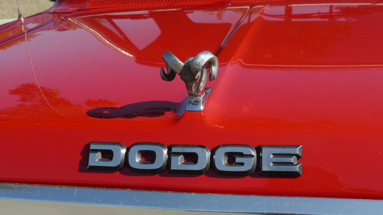 Cloes-up view of the Dodge logo on a red Dodge Ram car