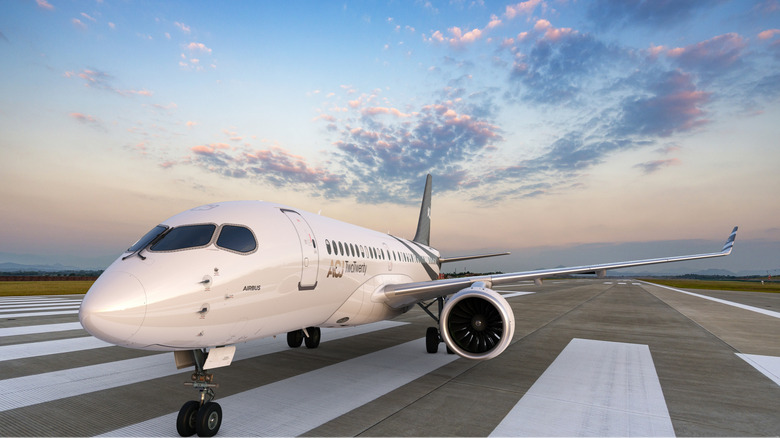 Airbus ACJ TwoTwenty seen from front left on a runway at twilight