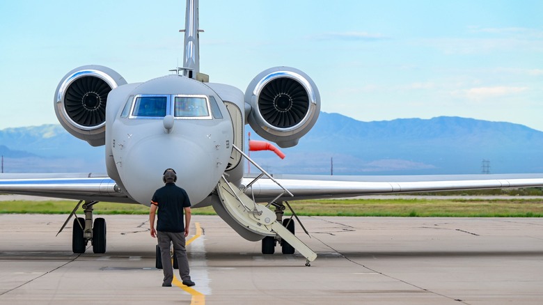 Ground crew standing in front of U.S. Air Force EA-37B on the runway