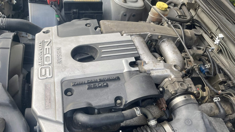 Nissan RB25DE NEO engine inside Skyline R34 engine bay, left-side view