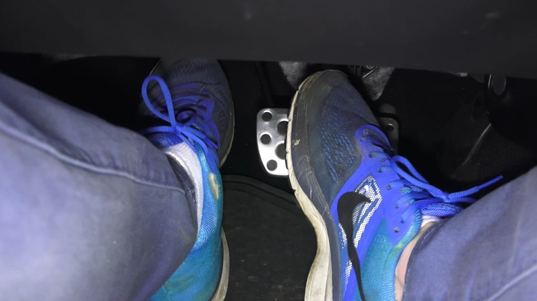 Close-up of driver's feet during heel-toe downshift maneuver