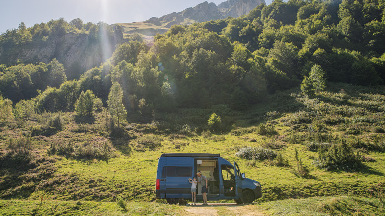 People in a camper in the wilderness