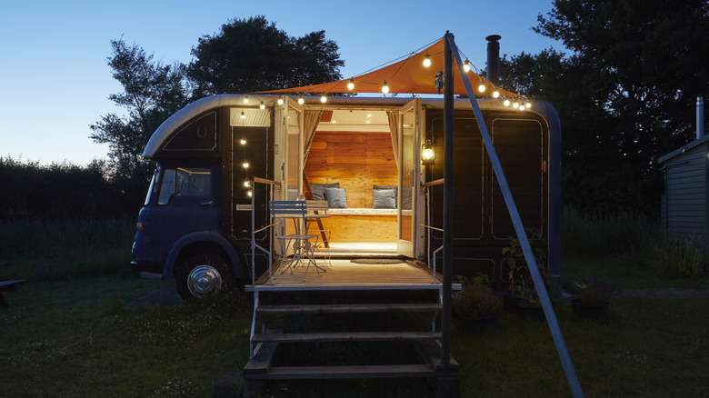 Converted horse trailer with lights around it