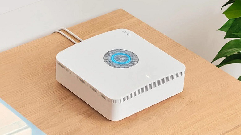 Ring Alarm Pro Base Station on a wooden texture table.
