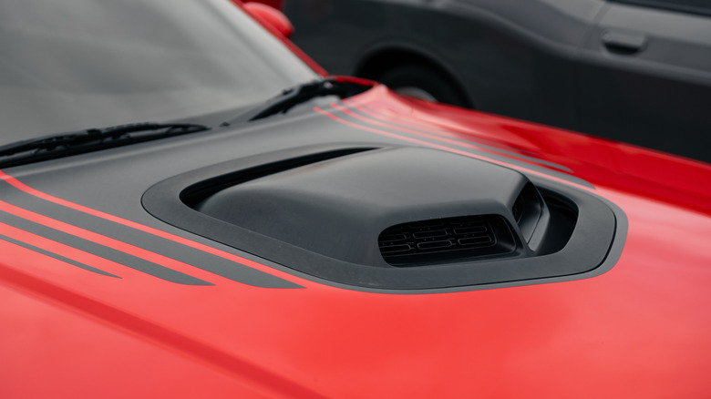 A close-up of a red car's hoodscoop.