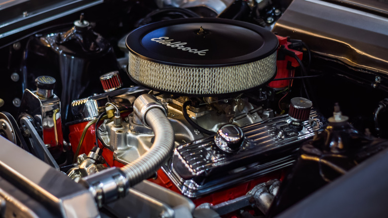 A close-up of a Chevy 350 small block pushrod V8 in an engine bay.