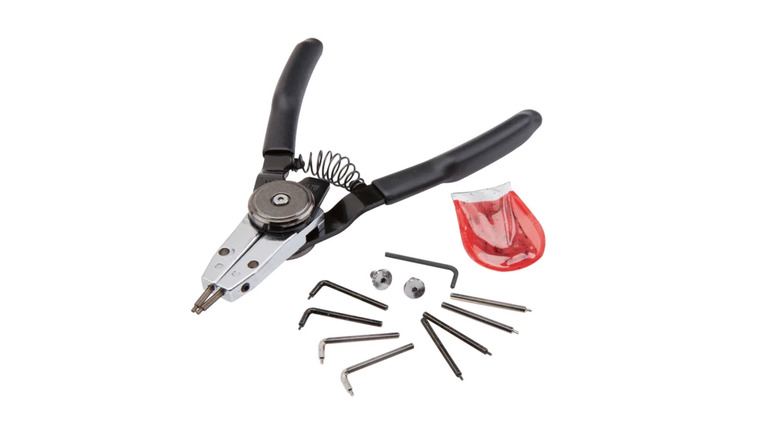 A pair of Quinn snap ring pliers and its accessories on a white background