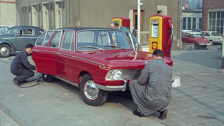 gas station employees servicing car