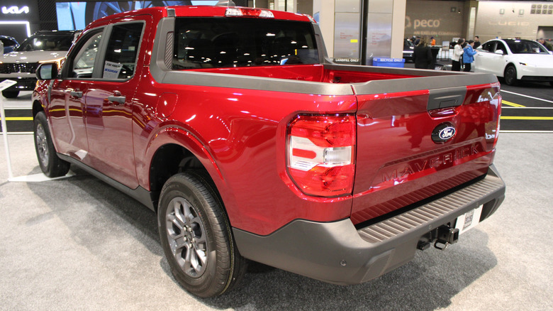 A rear shot of a red Ford Maverick on a convention floor