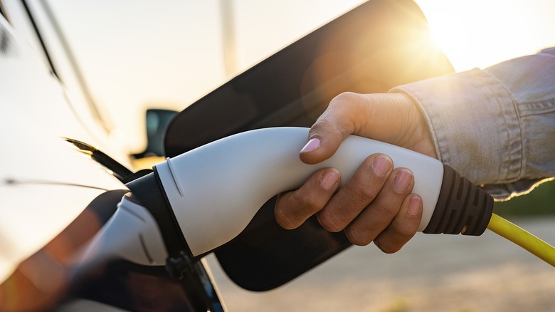 Plugging in an electric car charger