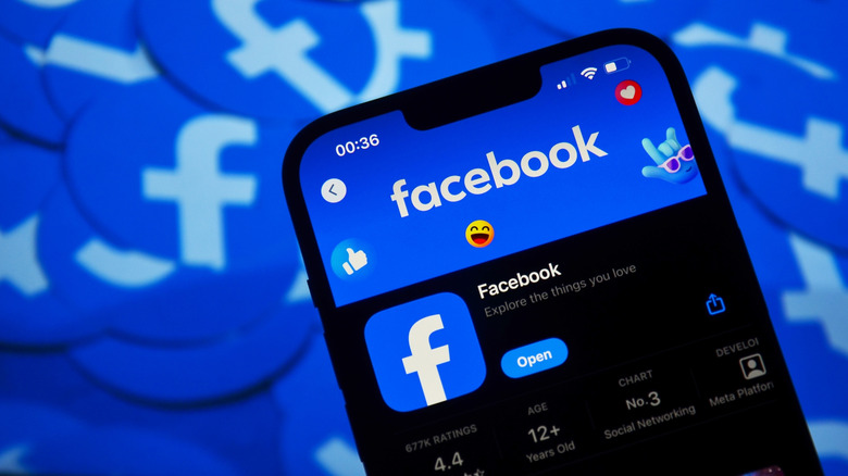 Facebook app on iphone with logo in the background