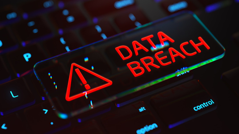 Data breach sign and text over keyboard