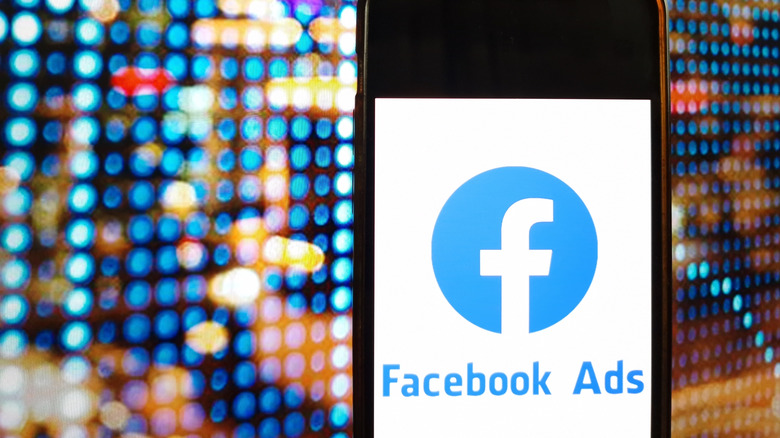 Facebook ads text on a phone screen