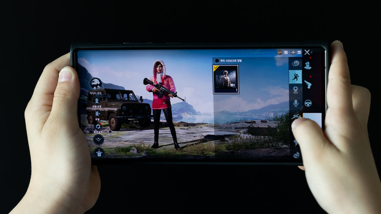 two hands holding a gaming phone